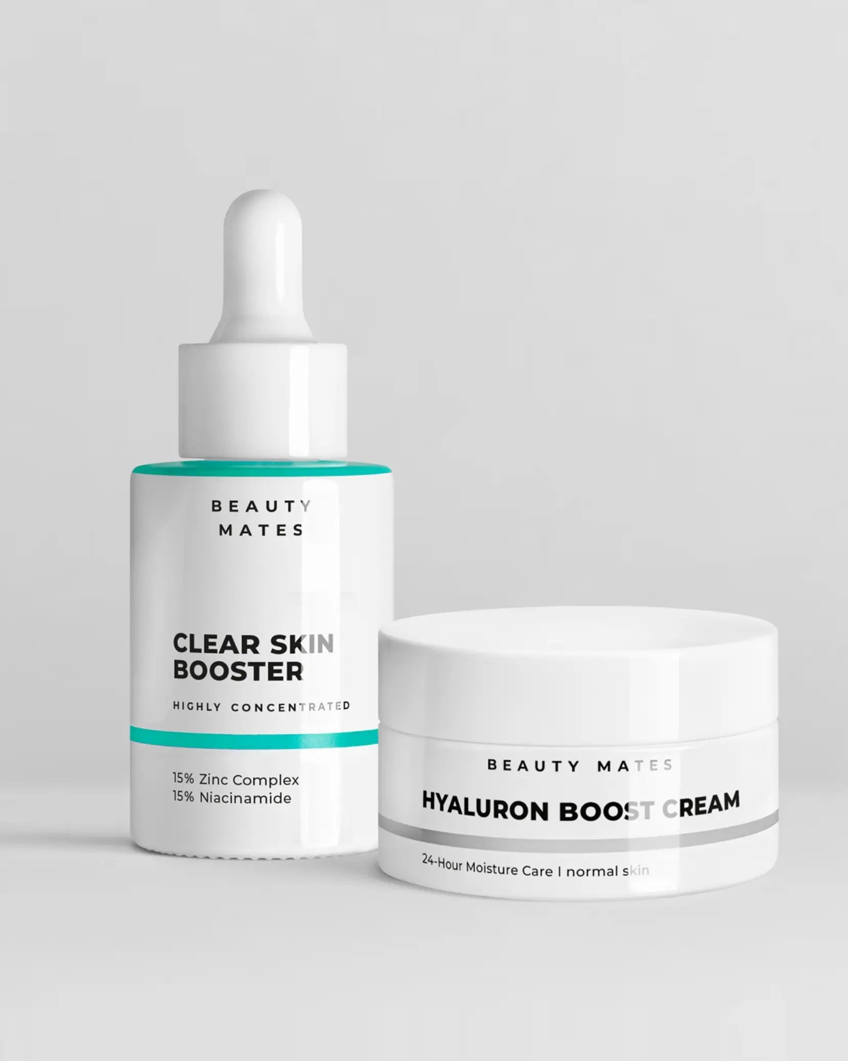 Beauty Mates Clear Skin Booster und Hyaluron Boost Cream nebeneinander auf grauem Hintergrund.